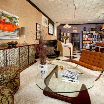 decorative room with a glass table and colorful chairs